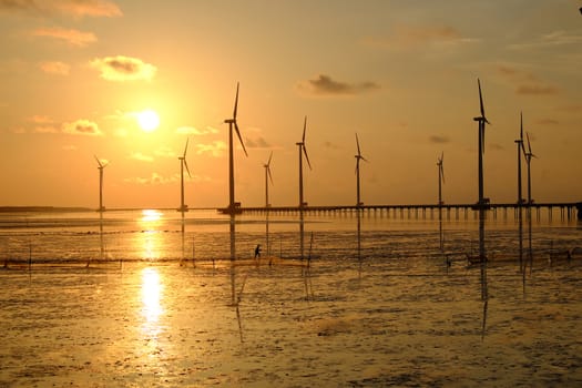 Group of wind turbines of Bac Lieu wind power plant at Mekong Delta, Vietnam. Windmill at Baclieu seaside at sunrise, make clean energy for Viet nam industry