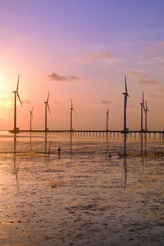 Group of wind turbines of Bac Lieu wind power plant at Mekong Delta, Vietnam. Windmill at Baclieu seaside at sunrise, make clean energy for Viet nam industry