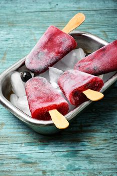 Ice-cream and summer berries in metal tray with ice