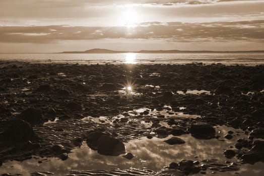 reflections at rocky beal beach near ballybunion on the wild atlantic way ireland with a beautiful yellow sunset