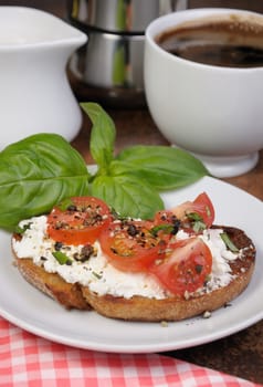 Bruschetta with ricotta and cherry tomatoes seasoned   spices, basil