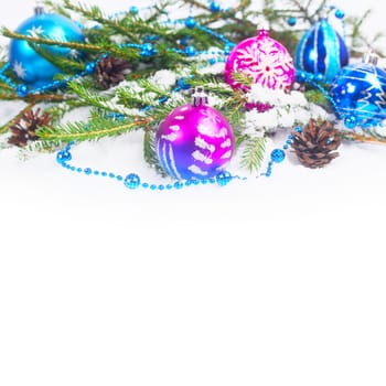 Christmas decorations and fir with pine cones on snow