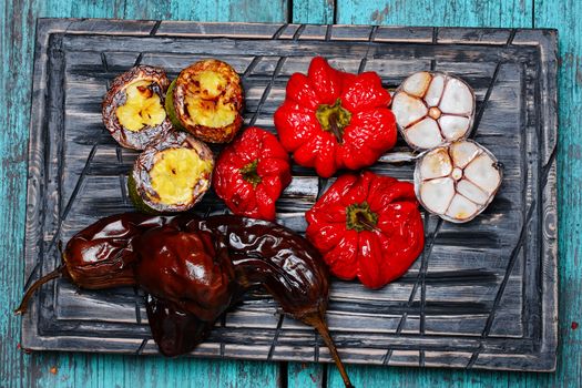 Baked eggplant,peppers and garlic on the kitchen board