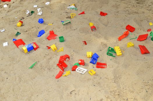 Children's sandbox with toys scattered.