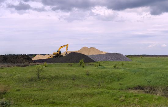 Yellow excavator working digging in sand quarry