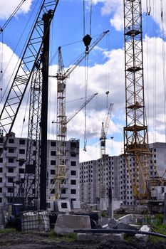  Construction site with cranes on sky background