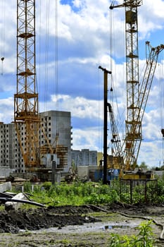  Construction site with cranes on sky background