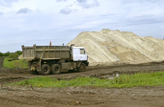  Yellow excavator working digging in sand quarry