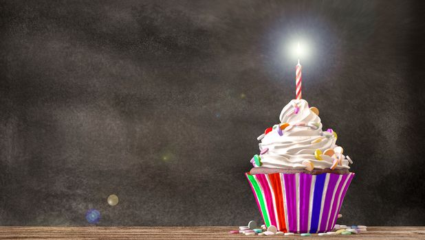 Cupcake with cream, candies and a candle on a wooden table with a blackboard background. Empty free copy space available. 3D Rendering