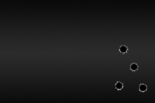 shotgun bullet hole on carbon fiber. metal background.