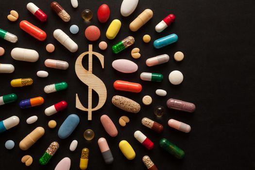 Wooden dollar sign surrounded by colorful pills