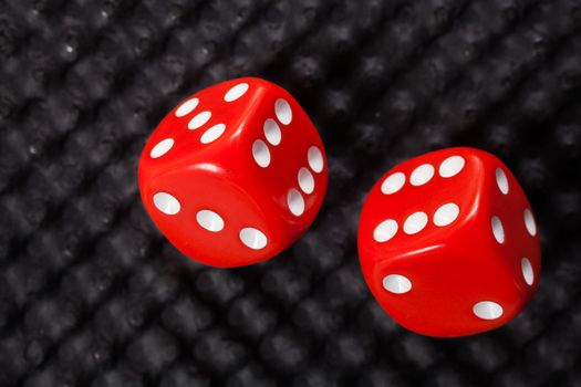 Red dice on black background