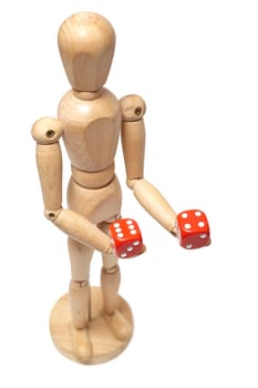 Wooden puppet holds dice on white background with clipping path