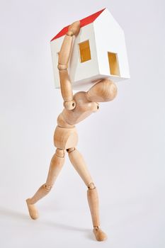 Dummy carrying small house on white background