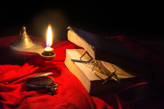 Torah is on the table, covered with a cloth, lit the lamp, man came out not long time left the glasses on the book