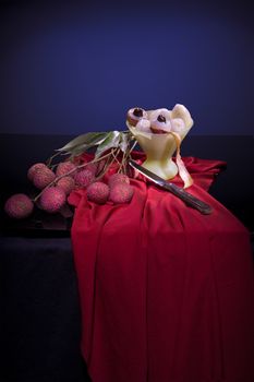 The branch of fruit Lychee and peeled fruit in glass