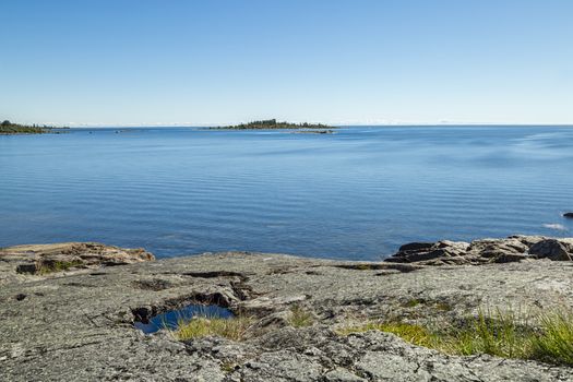 Shoreline by Ocean with small island.