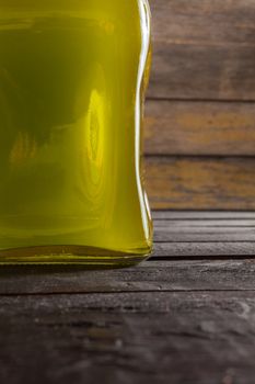 Olive oil bottle on wooden background