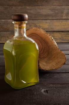 Olive oil bottle on wooden background