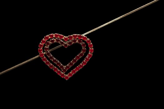 Heart-shaped necklace on black background