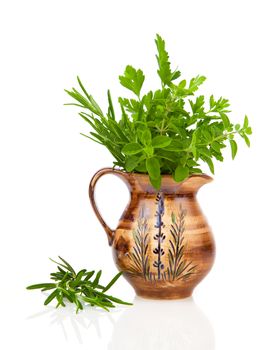 rosemary, oregano and parsley in a jar, on white background.