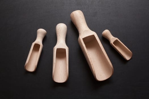 Wooden scoops - bailer isolated on a black background
