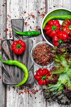 red pepper and paprika on iron plate with bright light background with spices