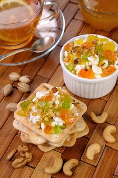 portion of cottage cheese with jam and marmalade, nuts on a cracker