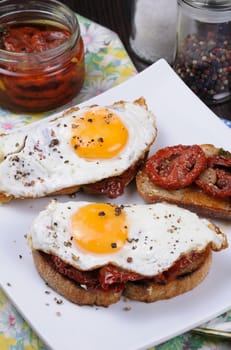 Sandwich with slices of dried tomatoes and egg flavored spices 