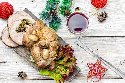 Dish of roulade of veal stuffed with mushrooms and spices and Christmas decorations