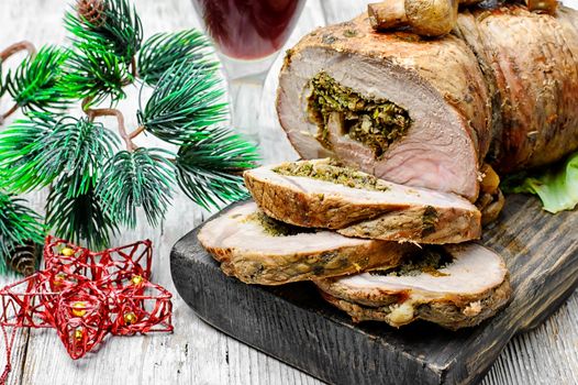 Dish of roulade of veal stuffed with mushrooms and spices and Christmas decorations