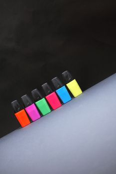 Set of color markers in a row on dark background