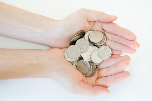 money and finances concept - close up of womans cupped hands showing coins