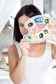 portrait of a teenager with colorful palette in hand