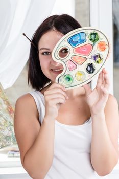 portrait of a teenager with colorful palette in hand