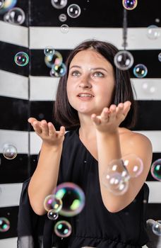portrait of young woman with soap bubbles