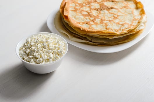 homemade pancakes on a white plate with cottage cheese