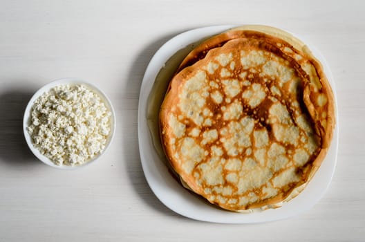 homemade pancakes on a white plate with cottage cheese