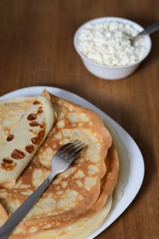 homemade pancakes on a white plate with cottage cheese