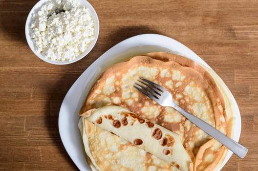 homemade pancakes on a white plate with cottage cheese