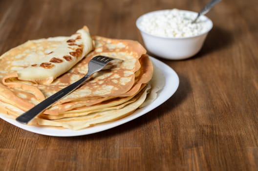 homemade pancakes on a white plate with cottage cheese