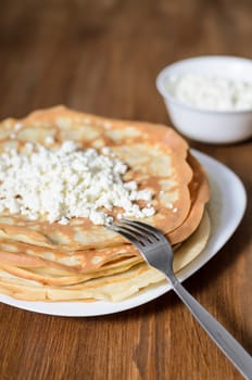 homemade pancakes on a white plate with cottage cheese