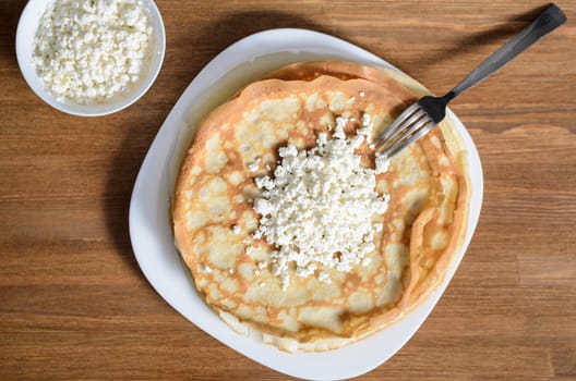 homemade pancakes on a white plate with cottage cheese