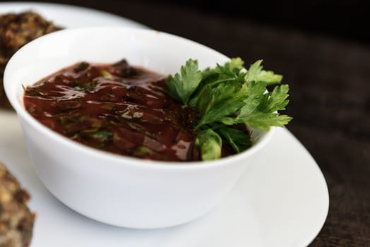 baked mushrooms with meat and sauce on a plate and wood