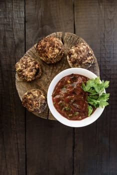 baked mushrooms with meat and sauce on a wood