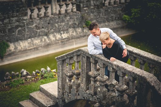 Young couple leaning on railing of bridge 