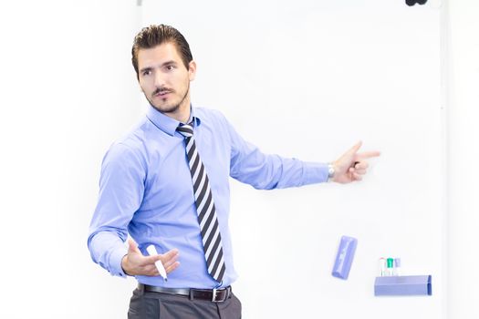 Business man making a presentation in front of whiteboard. Copy space.