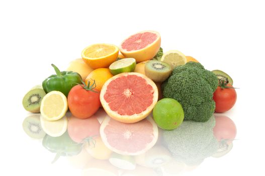 Selection of fruits and vegetables high in vitamin C over a white background 