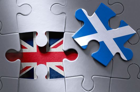 Missing piece from a UK jigsaw puzzle revealing UK flag with Scottish flag jigsaw piece on one side 