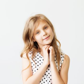 Closeup portrait of a lovely little girl in front of white background